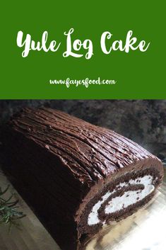 a close up of a cake on a table with the words yule log cake