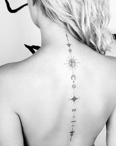 the back of a woman's neck with stars and planets on it