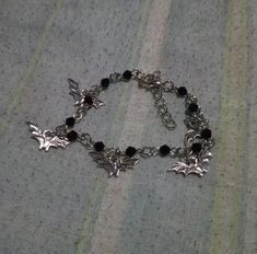 Embrace the dark side with our Gothic Bat Charm Bracelet, a striking accessory for any goth jewelry enthusiast. Featuring a gothic bat design, this bracelet is a statement piece that complements various styles and occasions, from casual wear to black bat dresses. The adjustable length, with a 4.5cm extension chain, ensures a perfect fit for wrists ranging from 17.5cm to 22cm or 20.5cm to 25cm. Crafted with durable materials, this bat mammal-inspired bracelet is built to withstand daily wear. It' Goth Jewelry Bracelets, Gothic Accessories Aesthetic, Vampire Goth Accessories, Vampiric Jewelry, Vampire Bracelet, Goth Bracelets, Bat Bracelet, Goth Jewellery, Accessories Gothic