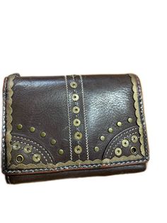 Brown leather wallet embellished with gold toned design elements Unisex trifold Card holder, bills and zippered compartment for change Brown Leather Wallet, Passport Wallet, Money Clip Wallet, Travel Wallets, Trifold Wallet, Vintage Bags, Coach Dinky Crossbody, Purse Wallet, Leather Wallet