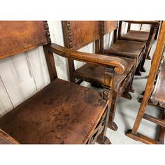 old wooden chairs lined up against a wall