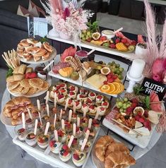 a table topped with lots of different types of foods and desserts next to each other