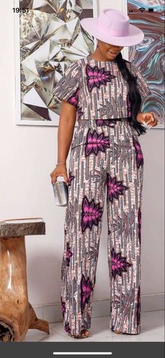 an ankara print blouse with high-waisted black pants Ankara Jumpsuits For Women, African Pants Suit, African Pants, Pant Suits For Women, African Print Dress Ankara, African Wear Dresses, African Inspired Clothing