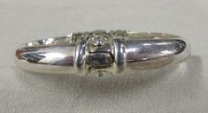 "Sterling silver and amethyst hinged bangle bracelet. The inside measures 6 5/8\". The bracelet is 5/16\" wide and domed. The hinge is in the back. There is a prong to keep the front well aligned. Stamped 925. Good condition. BB-1" Sterling Silver Clasp Cuff Bracelet For Formal Occasions, Classic Formal Cuff Bracelet With Sterling Silver Clasp, Formal Bangle With Sterling Silver Clasp, Hinged Sterling Silver Bangle For Formal Occasions, Silver Hinged Bangle For Anniversary, Formal Hinged Sterling Silver Bangle Bracelet, Elegant Hinged Sterling Silver Bracelet, Anniversary Silver Hinged Bangle, Classic Hinged Cuff Bracelet