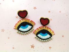 "These beaded evil eye earrings would make a perfect and unique gift for family, friend, or yourself. ★ READY TO SHIP Made with love and care for you!♥ ★DIMENSIONS: 6.5 * 5.5 cm (2.55 * 2.16 inches) ★Colors may vary slightly from photos due to lighting and monitor settings. ★ ESTIMATED DELIVERY TIME: North America: 2-4 weeks Europe: 1-3 weeks Australia, New Zealand and Oceania: 3-5 weeks Asia Pacific: 2-4 weeks Latin America and the Caribbean: 3-5 weeks North Africa and Middle East: 3-5 weeks Sub-Saharan Africa: 3-5 weeks ★ PLEASE NOTE: I accept payments via Paypal *you don't need to have an account* with a credit or debit card. 1. Click \"Pay with PayPal\" and you will be redirected to PayPal. Instead of paying with your PayPal account, select \"Pay with debit or credit card.\" 2. You wil Red Heart Earrings, Unique Jewelry Gifts, Evil Eye Earrings, Eye Earrings, Heart Earrings Studs, Red Heart, Heart Earrings, Evil Eye, Gifts For Family