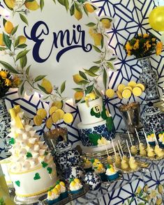 a table topped with lots of cakes and cupcakes