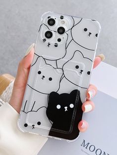 a woman holding up a phone case with cats on it and the back cover is clear