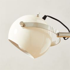 a white light with a black cord hanging from it's side and an object on the other side