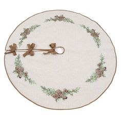 a round table mat with pine cones and bows