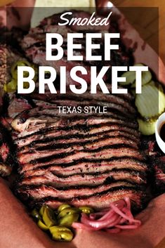 smoked beef brisket in a basket with pickles and sauce