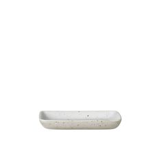 a white rectangular dish with speckled edges on a white background for use as a serving platter