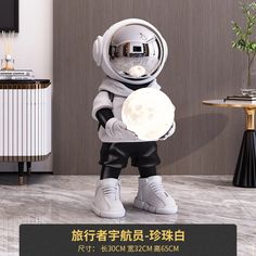 an astronaut is holding a white object in his right hand and standing on the floor