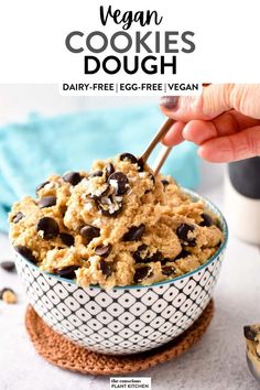 vegan cookies dough in a white and black bowl with chocolate chips on the side