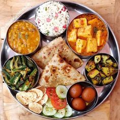 a metal plate topped with different types of food