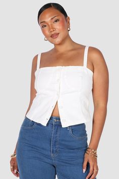 Denim on denim is making a comeback with our Siren Denim Top white out! A new take on our previous design, with matching stitching to compliment this wear-on-repeat item. A top made to be seen - wear this one with any of your denim pieces in your wardrobe for the ultimate cool girl vibe! With a flattering straight neckline and adjustable shoulder straps, this structured top will be a timeless piece in your wardrobe. Why you'll love this: Take her from the office to drinks with no fuss, she is the ultimate versatile style Double denim is so in right now - bring back the 90's nostalgia by pairing her with your Fayt jeans Adjust the buttons depending on your vibe, she can be worn partially open or completely done up! The details: Ultra stretchy fit Stitching throughout Functional buttons Adju Casual White Cotton Denim Top, White Denim Top For Spring, White Casual Denim Top For Spring, White Cotton Denim Top For Summer, White Casual Denim Top For Summer, White Trendy Denim Top For Spring, Trendy White Denim Top For Spring, Trendy Cropped Cotton Denim Top, White Denim Casual Tops