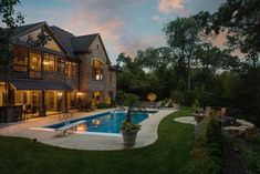 a large house with a swimming pool in the middle of it's lawn area