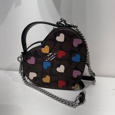 Bestseller Signature Coated Canvas And Smooth Leather Two Credit Card Slots Double Zip Closure, Fabric Lining Top Handle With 2" Drop Detachable Strap With 22 1/2" Drop For Shoulder Or Crossbody Wear 6" (L) X 7" (H) X 2 1/2" (W) Style No. Cp022 Chic Coach Heart-shaped Bag, Designer Heart-shaped Leather Bag, Coach Heart-shaped Bag For Valentine's Day, Multicolor Coach Bags As Gifts, Brown Heart-shaped Bag, Bags Coach, Signature Canvas, Heart Print, 7 H