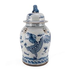 a blue and white vase with a dragon on it's lid is shown in front of a white background