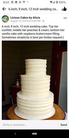 a white wedding cake sitting on top of a wooden table