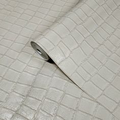 a close up view of a white wallpaper with an embossed pattern on it