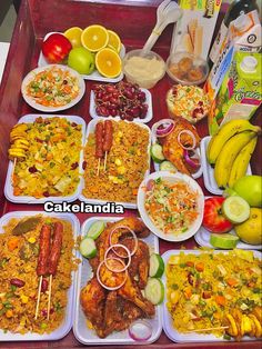 a tray filled with lots of food and fruit on top of it next to other foods