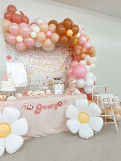 a table with balloons and flowers on it