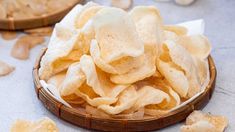 a wooden bowl filled with chips on top of a table