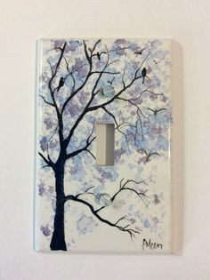 a light switch cover with a painting of a tree and birds on it's branches