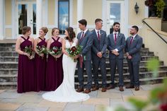 a group of people standing next to each other in front of a building with stairs