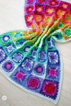 two crocheted afghans sitting on top of a wooden floor