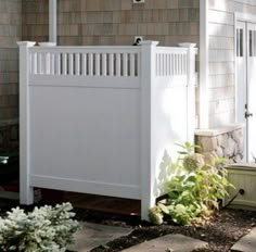 a white fence in front of a house