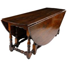 an old wooden table with turned over legs