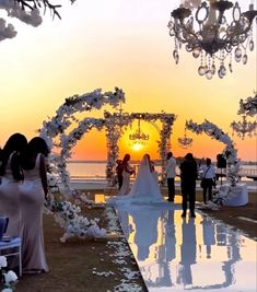 a bride and groom are walking down the aisle at their wedding ceremony on the beach