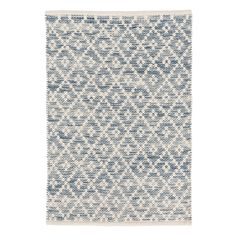 a blue and white rug with diamond shapes on the bottom, in front of a white background