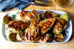 grilled chicken with lemons and herbs on a plate