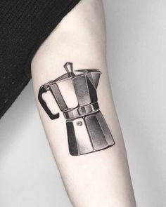 a black and white coffee pot tattoo on the arm