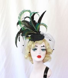 Black Feather Fascinator with Dotted Veil, Showgirl Peacock Headpiece, High Fashion Hat, Ascot Races, Kentucky Derby, Halloween Wedding This hat is huge and fantastic. It is made from a sturdy hand blocked buckram base (I use two layers of buckram) that has been wired and then covered in felt and then covered in a black brushed satin. A spray of huge black iridescent coquille feathers and perfectly curled peacock swords set on top of this perfectly you can wear it on either side of your head for Fitted Black Hat For Carnival, Fitted Feathered Costume Hat, Adjustable Fascinator For Costume Carnival, Adjustable Fascinator For Carnival Costume, Fitted Feathered Costume Hats And Headpieces, Vintage Fitted Costume Hats And Headpieces For Carnival, Feathered Fitted Costume Hat, Vintage Fitted Costume Hats For Carnival, Fitted Costume Hat With Feathers