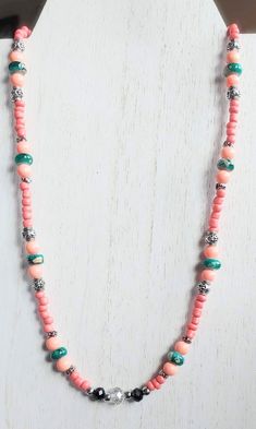 This necklace is made with green spotted beads, pink round beads, pink seed beads, silver spacer beads, and a clear rondelle in the middle. Toggle clasp. Measures 20 inches long end to end. Pink Round, Homemade Jewelry, Pink Necklace, Pink Beads, Shades Of Pink, Toggle Clasp, Jewelry Diy, Spacer Beads, Round Beads