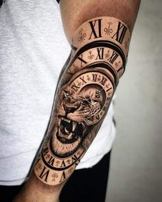 a man with a tattoo on his arm has a clock and lion face on it