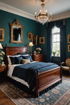 a bedroom with green walls, blue bedding and gold framed pictures on the wall