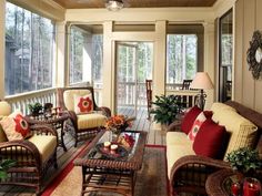 a living room with wicker furniture and lots of windows on the outside wall to let in natural light