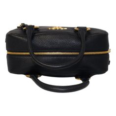 This classic Prada satchel bag is the perfect choice for an everyday look. The handbag is crafted with pebbled leather and features gold-tone hardware and the Prada logo on the front face. The two-way zipper opens to a black fabric interior with two interior pockets. The multi-colored web strap adds a unique yet elegant touch. Look no further for a luxurious wardrobe staple by Prada. Model number: 1BB086 Color: Nero Vitello Phenix calfskin leather Gold-tone hardware Two-way zipper fastening Blac Luxury Pebbled Leather Satchel With Branded Hardware, Formal Pebbled Leather Bag With Zipper Closure, Pebbled Leather Satchel With Branded Hardware For Travel, Travel Satchel With Branded Hardware And Pebbled Leather, Luxury Pebbled Leather Bag With Branded Hardware, Prada Satchel, Luxurious Wardrobe, Hobo Tote Bag, Prada Model