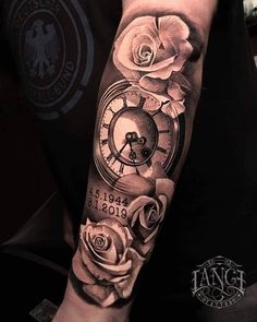 a man's arm with roses and an old clock tattooed on the arm,