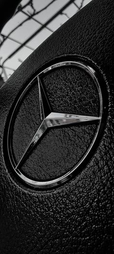 the mercedes logo is shown in this black and white photo, with its hood up