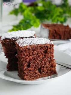 two pieces of chocolate cake on a white plate