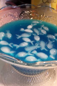 a blue liquid in a glass bowl on a table