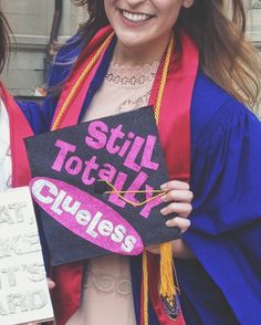 a woman holding a sign that says still totally quelles on it and smiling at the camera