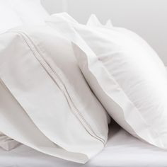 two white pillows are stacked on top of each other