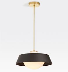 a black and gold pendant light hanging from the ceiling with an oval shade on it