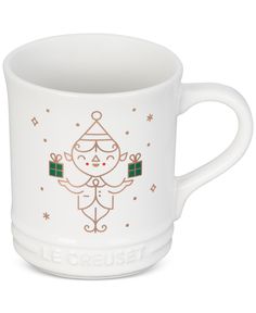 a white coffee cup with an image of a woman holding a christmas tree on it